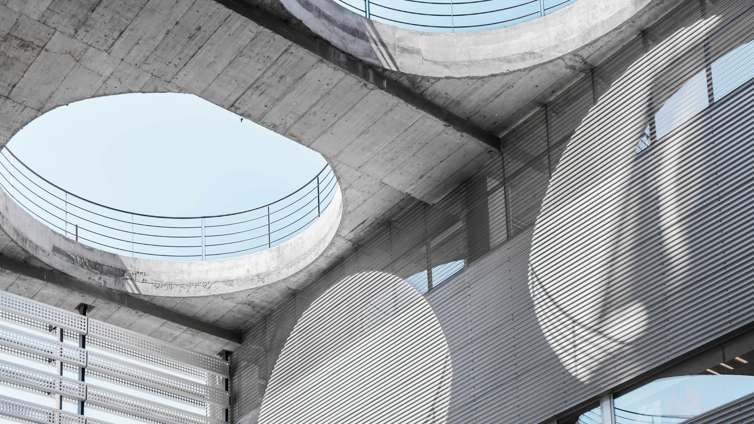 Concrete atrium with round skylights, seen from below